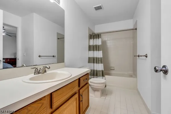 a bathroom with a sink toilet a mirror and shower