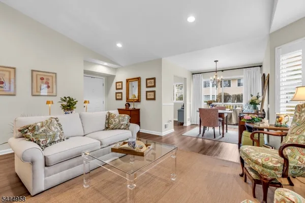 a living room with furniture dining area and a window