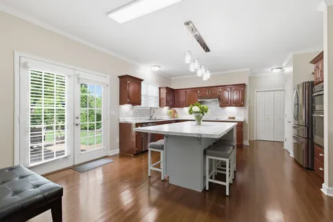 a kitchen with a table chairs refrigerator and microwave
