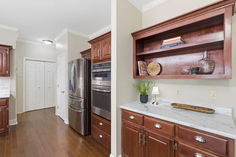 a kitchen with stainless steel appliances granite countertop a refrigerator and a stove
