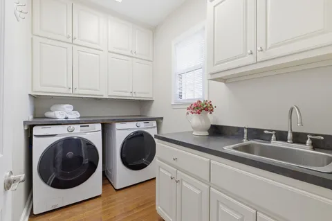 a kitchen with white cabinets and a sink