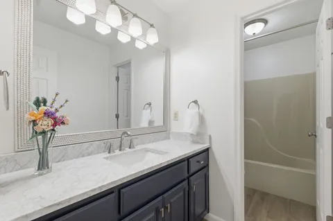 a bathroom with a sink a vanity and a mirror