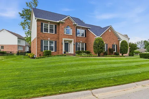 a front view of house with yard and green space