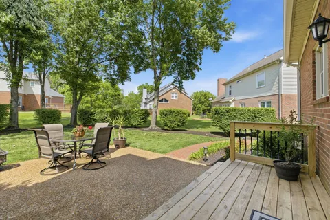 a view of a house with backyard sitting area and garden