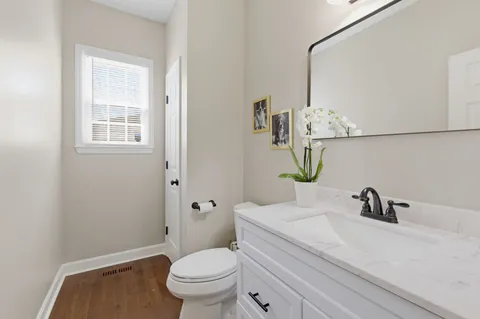 a bathroom with a sink a toilet and mirror