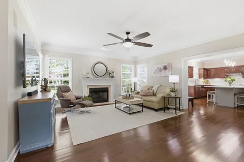a living room with furniture fireplace and a window