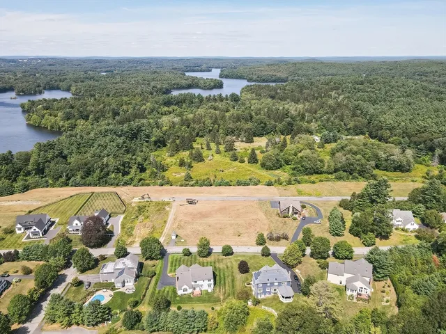 a view of a house with a yard and lake view