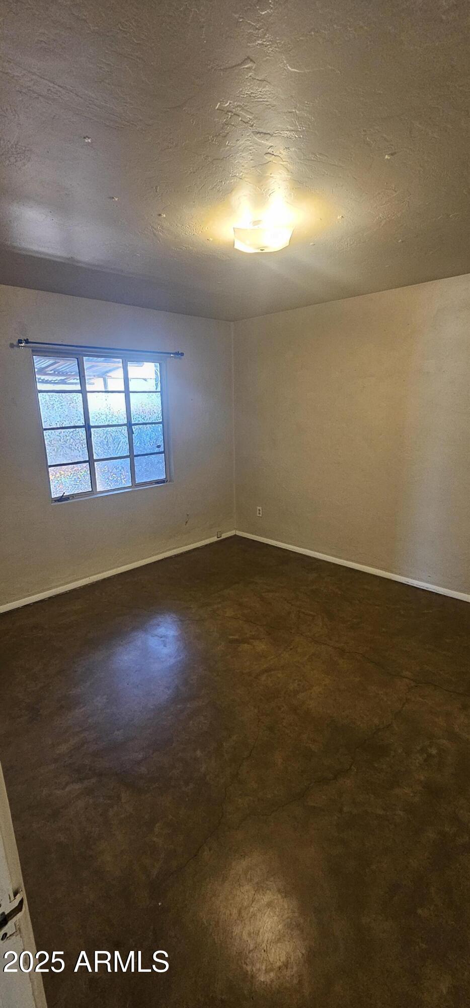 1234 South Farmer Avenue Tempe, AZ 85281 - Photo 11 of 47 an empty room with wooden floor and windows in it