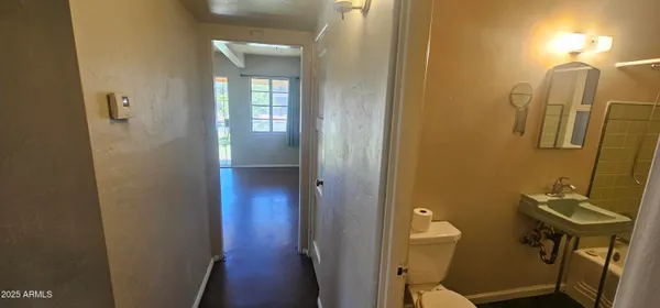 a bathroom with a sink a toilet and mirror
