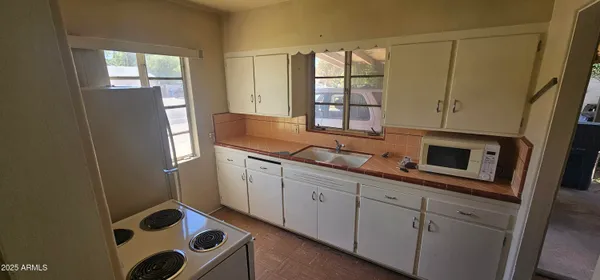 a kitchen with stainless steel appliances a refrigerator sink and cabinets