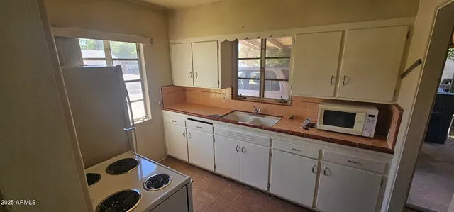 a kitchen with stainless steel appliances a refrigerator sink and cabinets