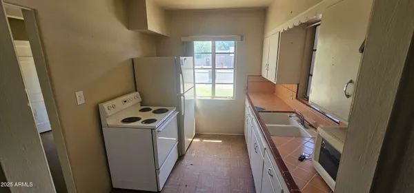 a view of walk in closet with wooden floor washer and dryer