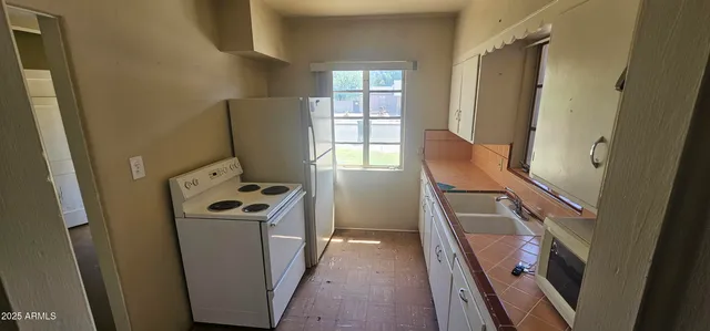 a view of walk in closet with wooden floor washer and dryer