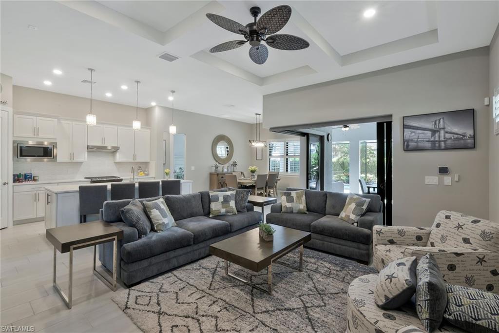 9640 Everglades Boulevard North Naples, FL 34120 - Photo 13 of 49 a living room with furniture and a large window