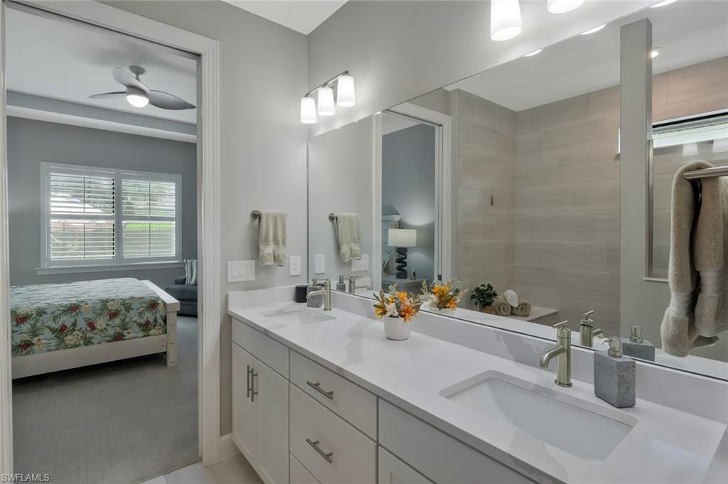 9640 Everglades Boulevard North Naples, FL 34120 - Photo 18 of 49 a en suite bathroom with double sink and a mirror