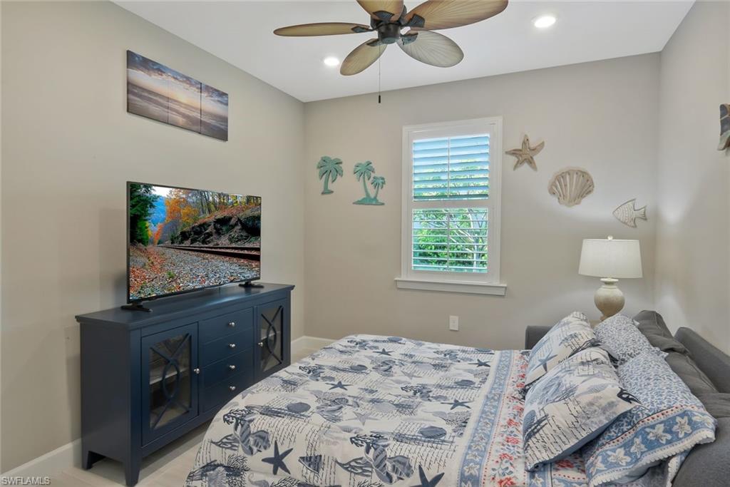 9640 Everglades Boulevard North Naples, FL 34120 - Photo 21 of 49 a bedroom with a bed and a flat tv screen on dresser