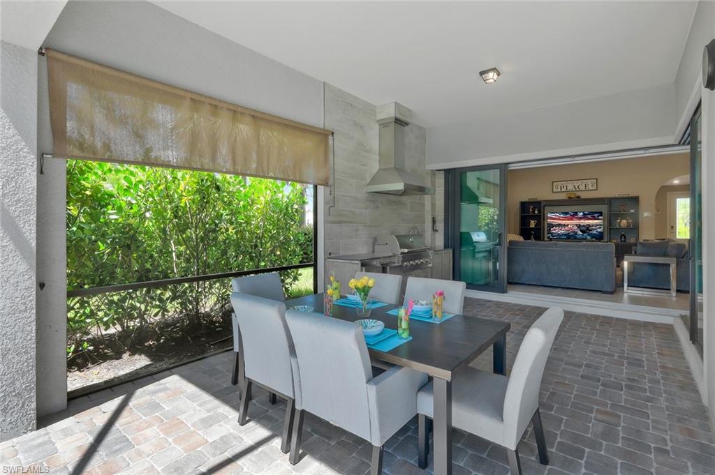 9640 Everglades Boulevard North Naples, FL 34120 - Photo 26 of 49 a dining room with furniture window and wooden floor