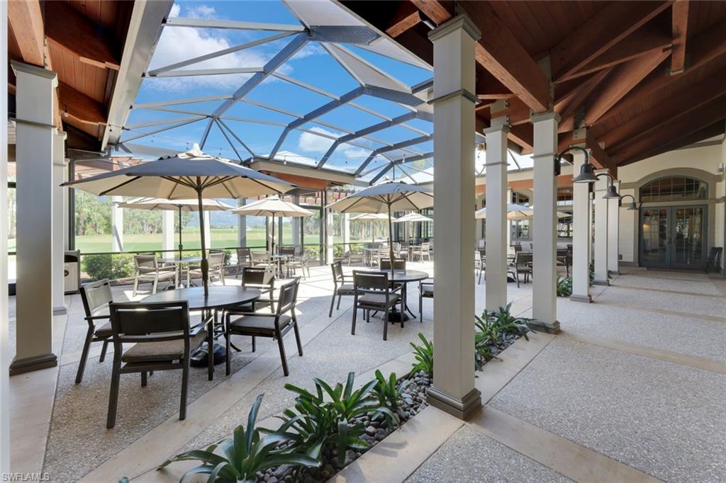 9640 Everglades Boulevard North Naples, FL 34120 - Photo 49 of 49 a view of a patio with chairs and potted plants