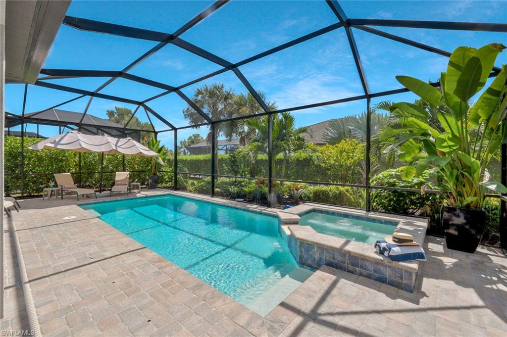 9640 Everglades Boulevard North Naples, FL 34120 - Photo 6 of 49 a view of a swimming pool with a patio