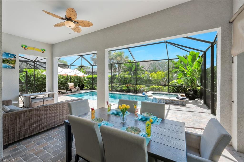 9640 Everglades Boulevard North Naples, FL 34120 - Photo 7 of 49 a dining room with furniture water view and a floor to ceiling window