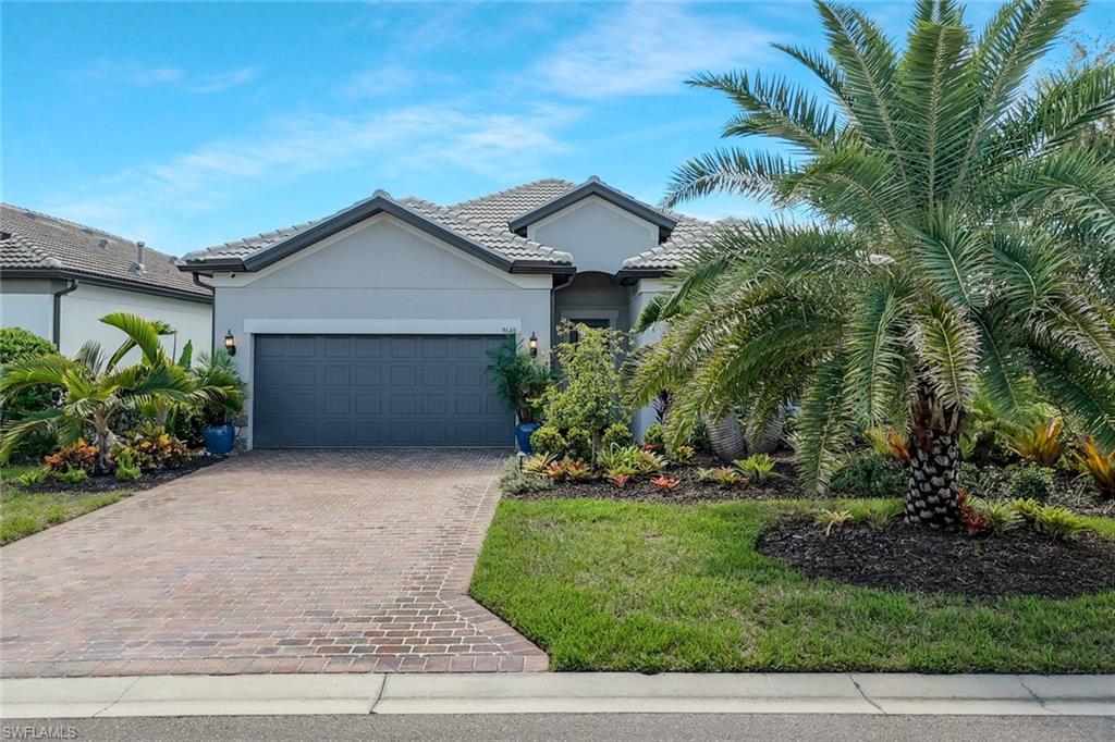 9640 Everglades Boulevard North Naples, FL 34120 - Photo 9 of 49 a front view of house with yard and green space