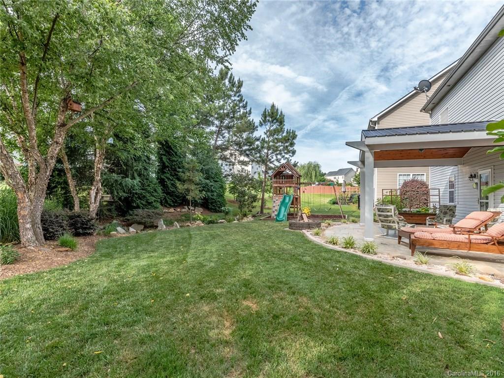 13426 Meadowmere Road, Unit 45 Huntersville, NC 28078 - Photo 22 of 24 a view of a house with backyard sitting area and garden