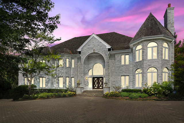 a front view of a house with a garden