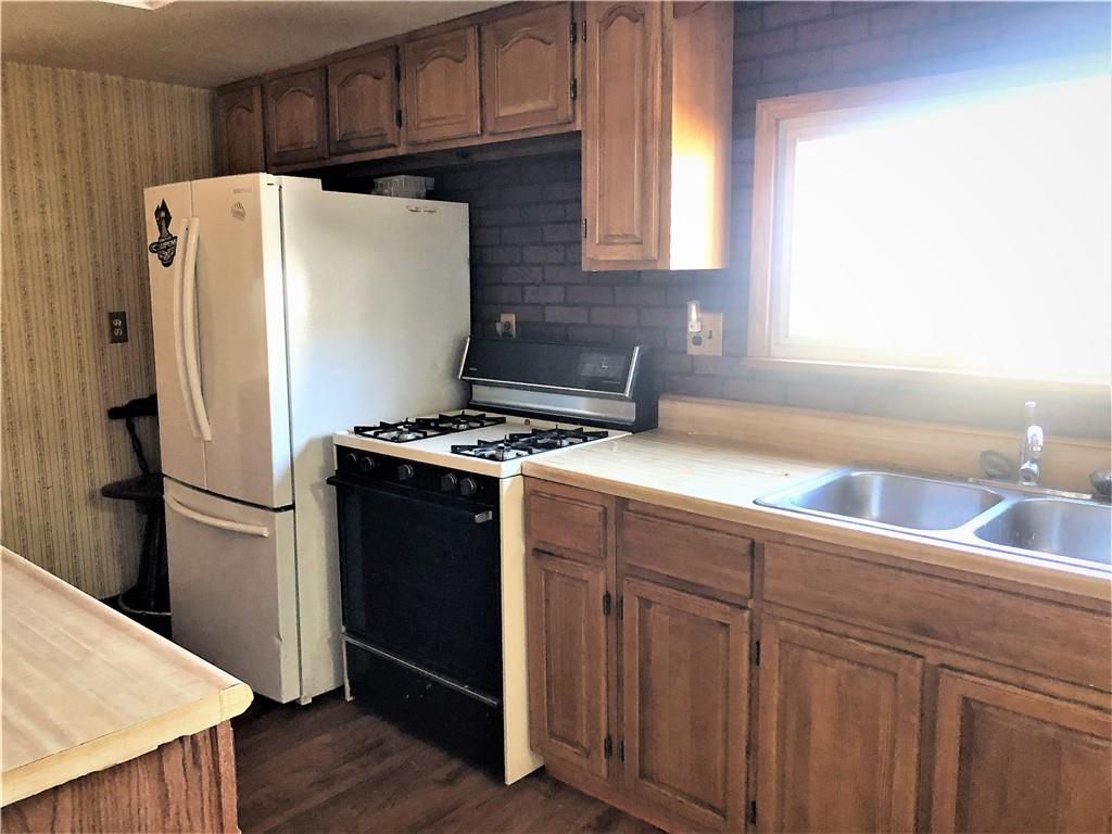 651 Lone Pine Road Washington, PA 15301 - Photo 5 of 16 a white refrigerator freezer sitting in a kitchen