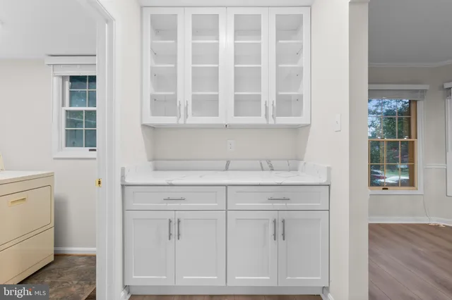 a view of a room with wooden floor and windows