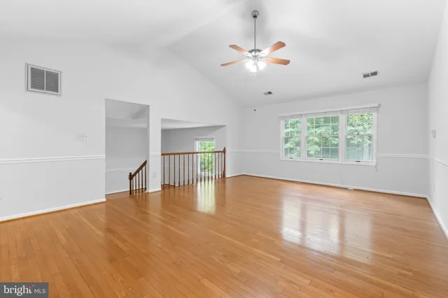 a view of a house with a big yard and large tree