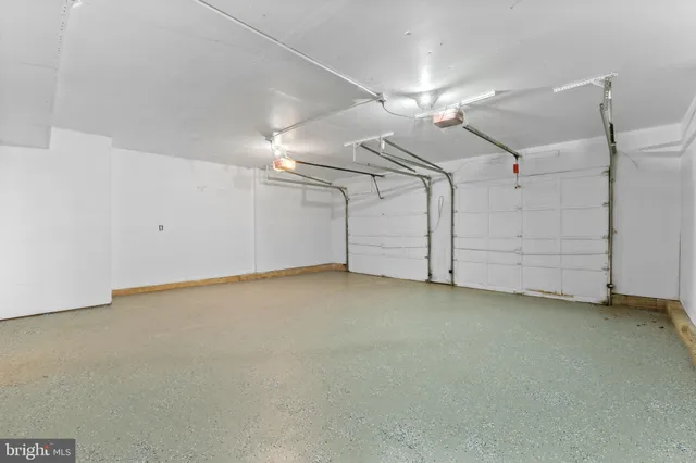 a white bath tub sitting next to a white sink and vanity