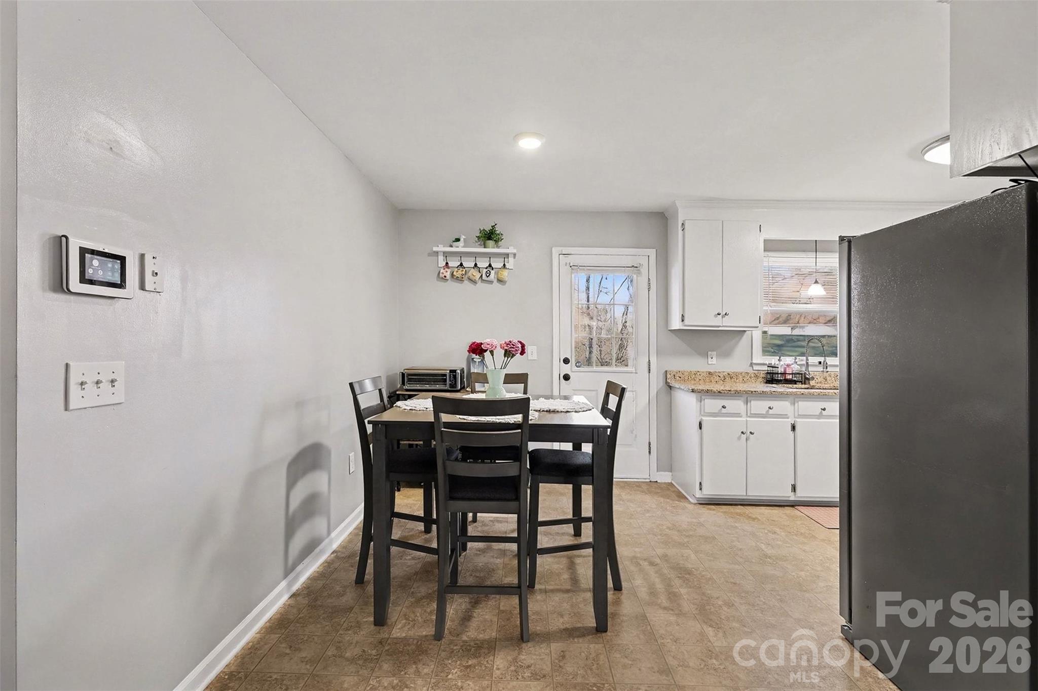 1318 Ridgewood Drive Concord, NC 28027 - Photo 12 of 27 a view of a dining room with furniture and window