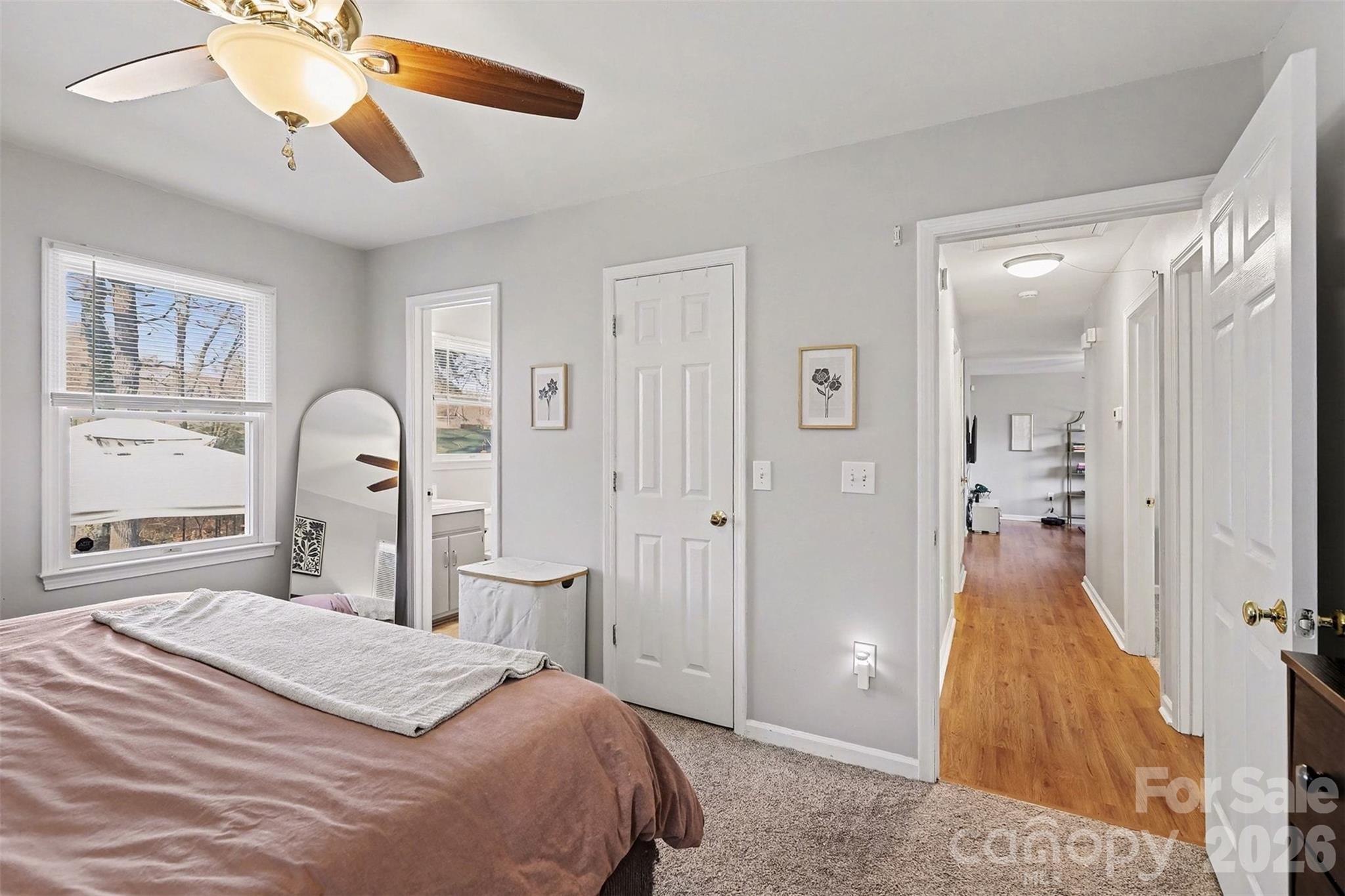 1318 Ridgewood Drive Concord, NC 28027 - Photo 13 of 27 a bedroom with a bed and a chandelier