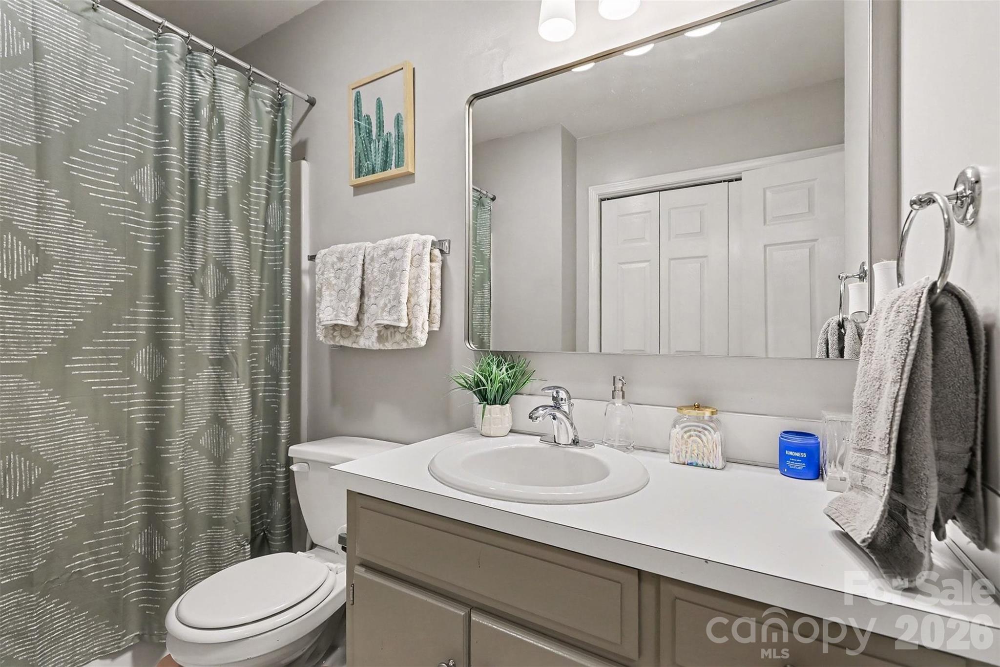 1318 Ridgewood Drive Concord, NC 28027 - Photo 15 of 27 a bathroom with a sink a toilet and shower curtain