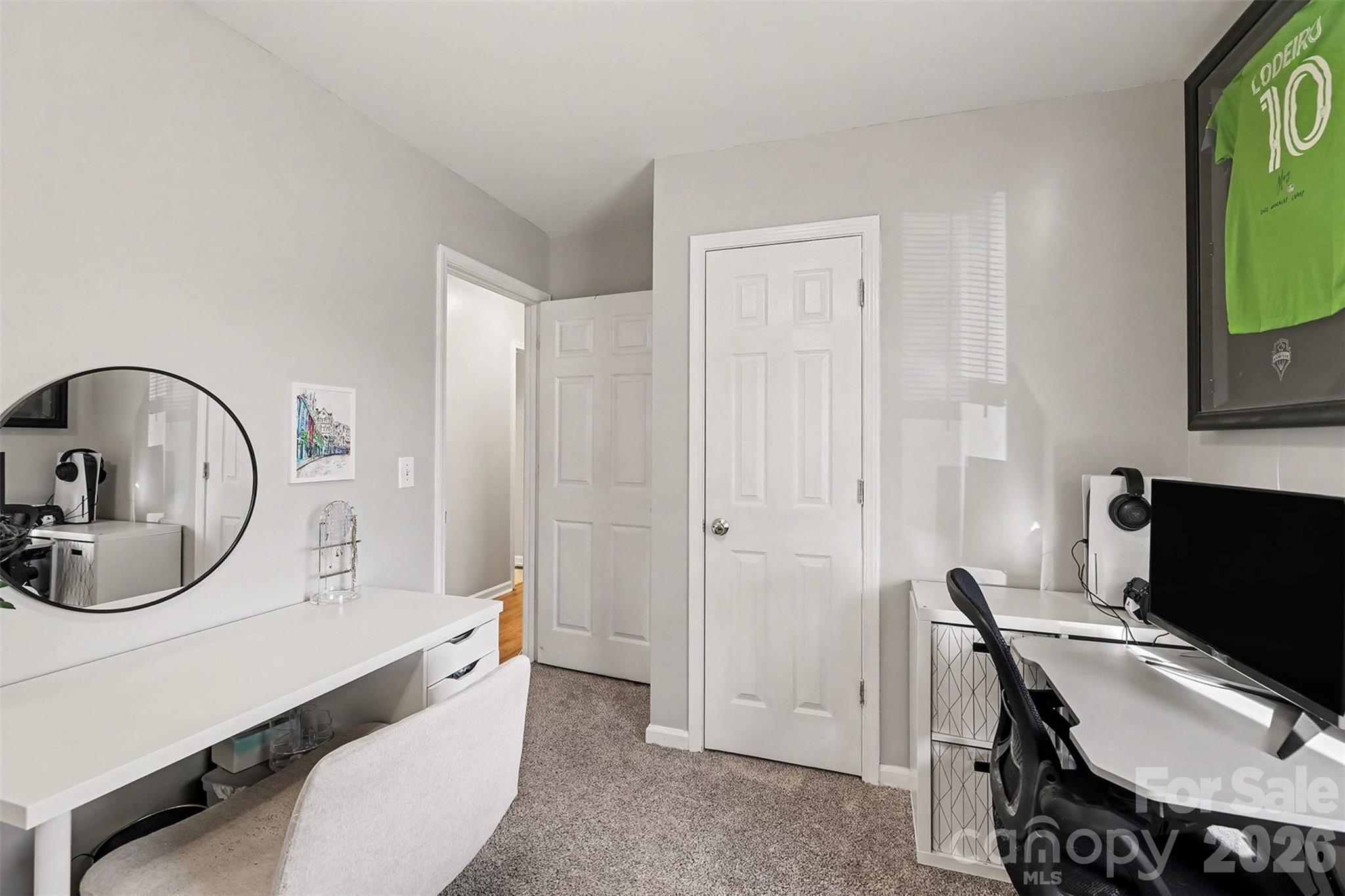 1318 Ridgewood Drive Concord, NC 28027 - Photo 18 of 27 a room with a chair a computers on the table and a flat screen tv