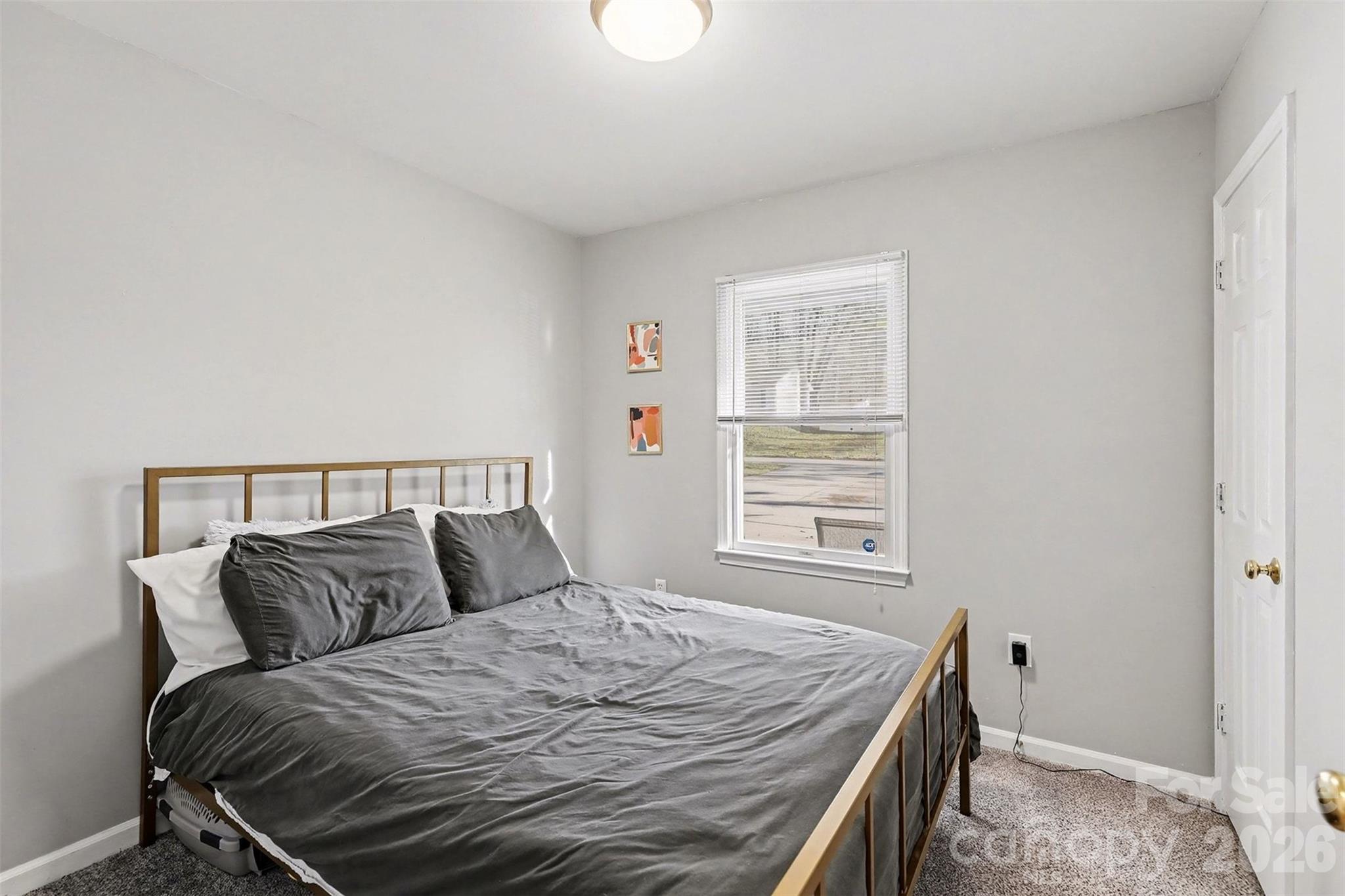 1318 Ridgewood Drive Concord, NC 28027 - Photo 19 of 27 a bedroom with a bed and wooden floor