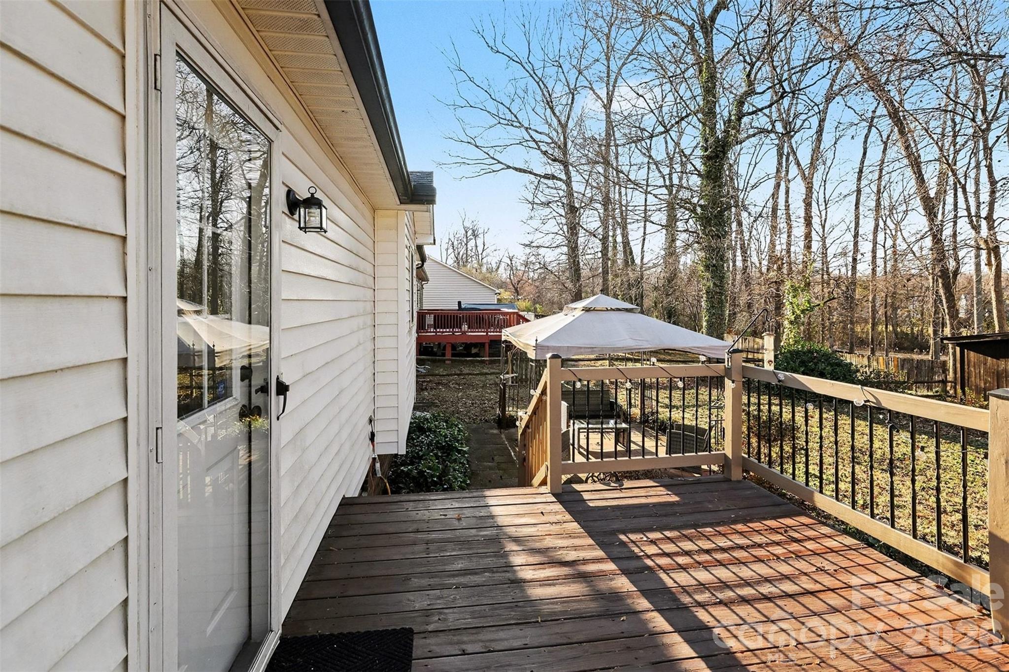 1318 Ridgewood Drive Concord, NC 28027 - Photo 23 of 27 a view of a wooden deck with an umbrella