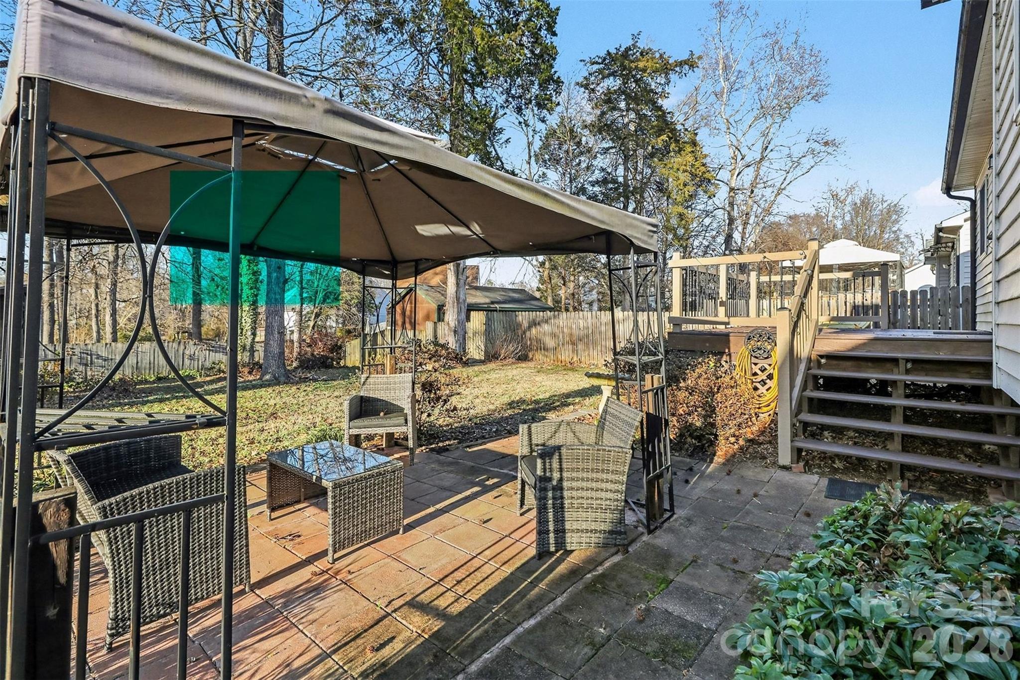 1318 Ridgewood Drive Concord, NC 28027 - Photo 24 of 27 a view of a patio with table and chairs under an umbrella