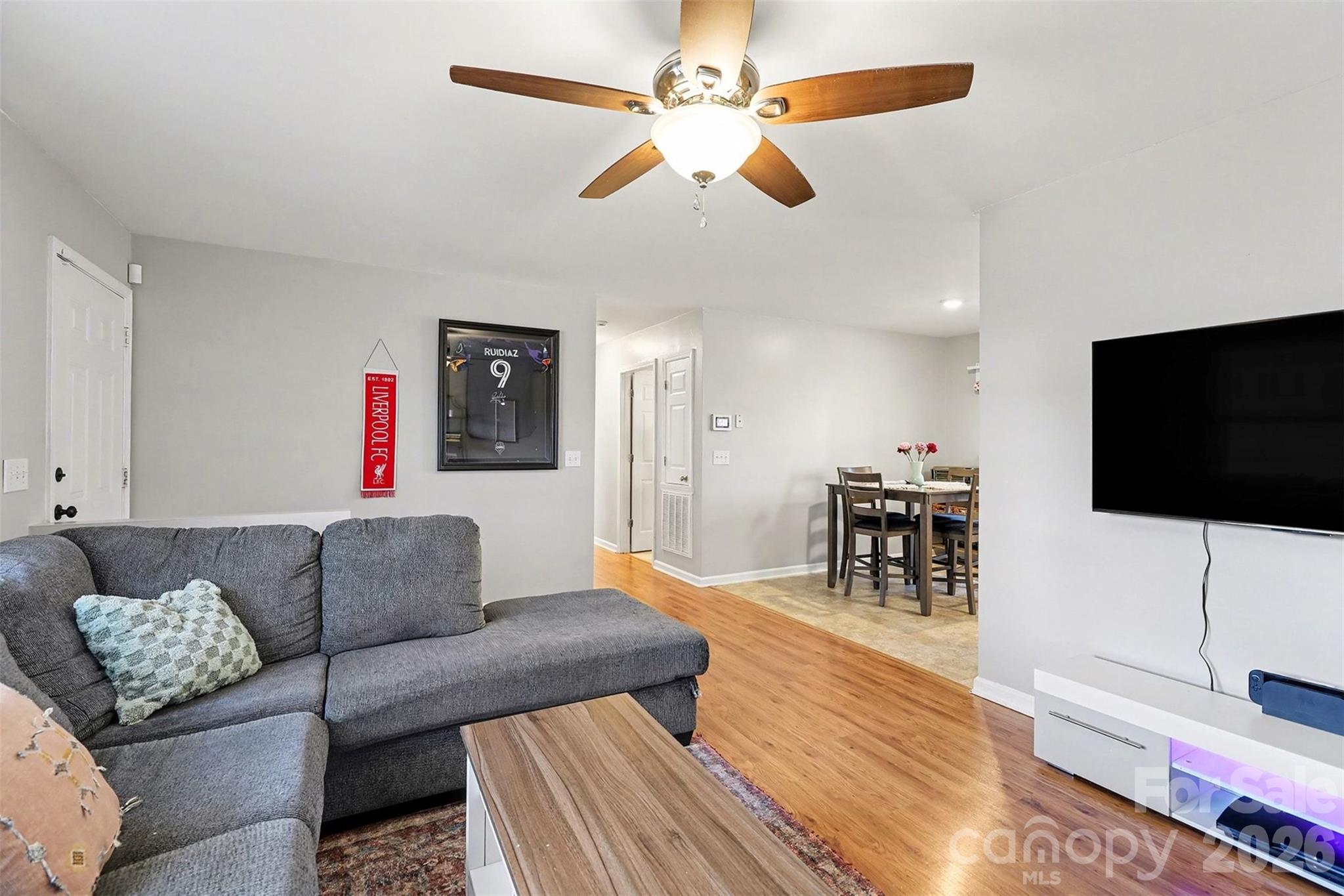 1318 Ridgewood Drive Concord, NC 28027 - Photo 5 of 27 a living room with furniture and a flat screen tv