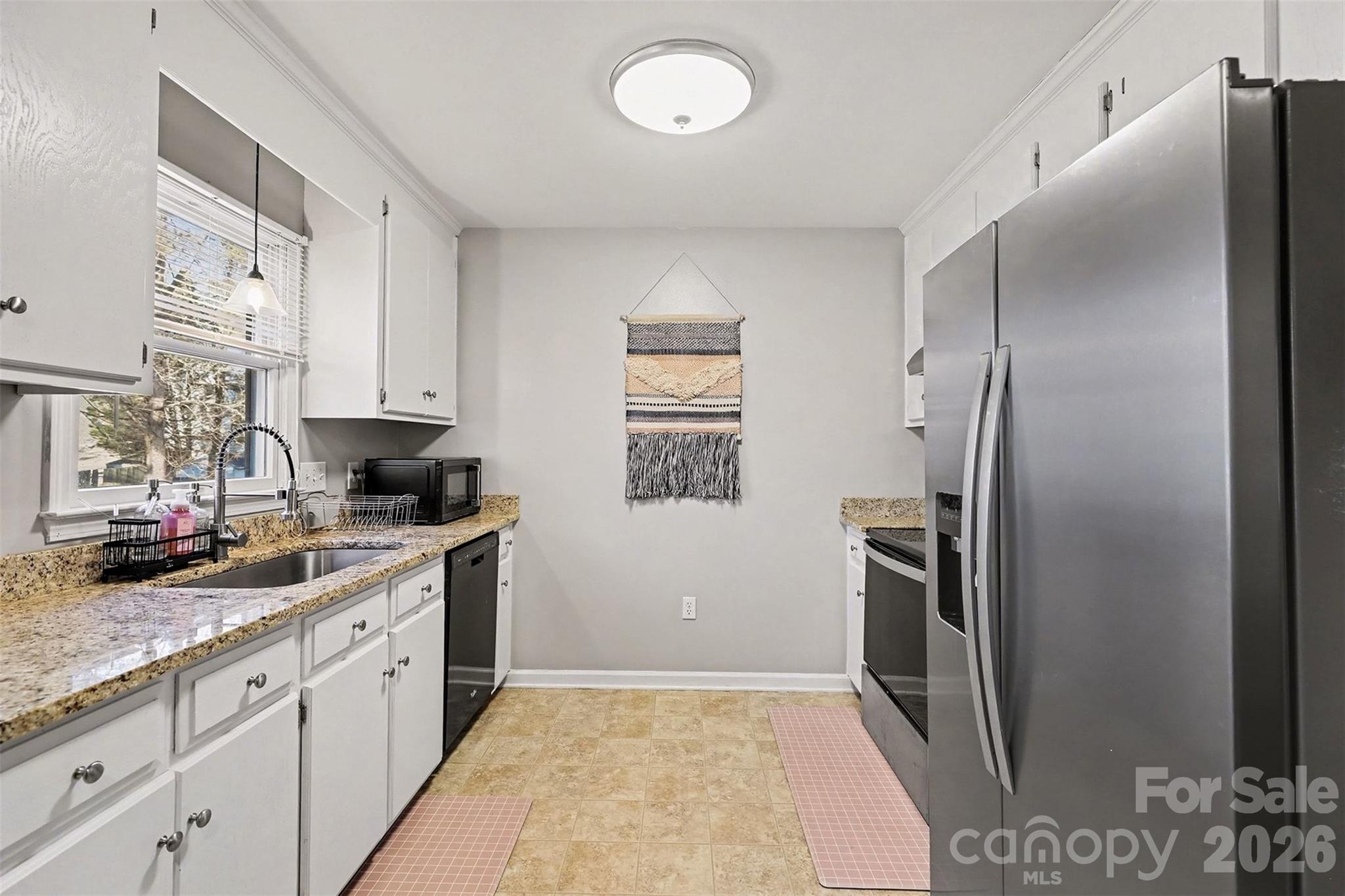 1318 Ridgewood Drive Concord, NC 28027 - Photo 7 of 27 a kitchen with stainless steel appliances granite countertop a refrigerator and a sink