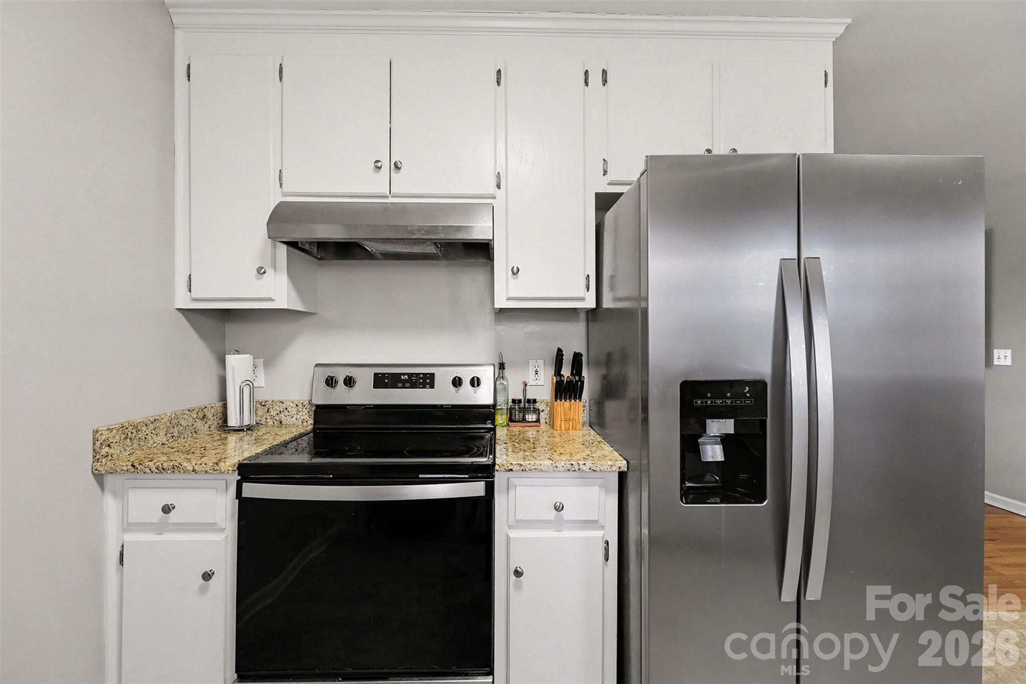 1318 Ridgewood Drive Concord, NC 28027 - Photo 10 of 27 a kitchen with stainless steel appliances granite countertop a stove a refrigerator and a cabinets