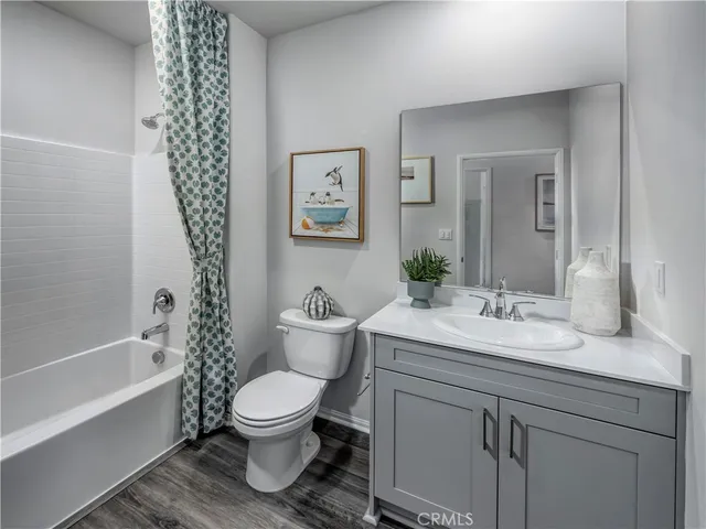 a bathroom with a granite countertop toilet a sink and a bathtub