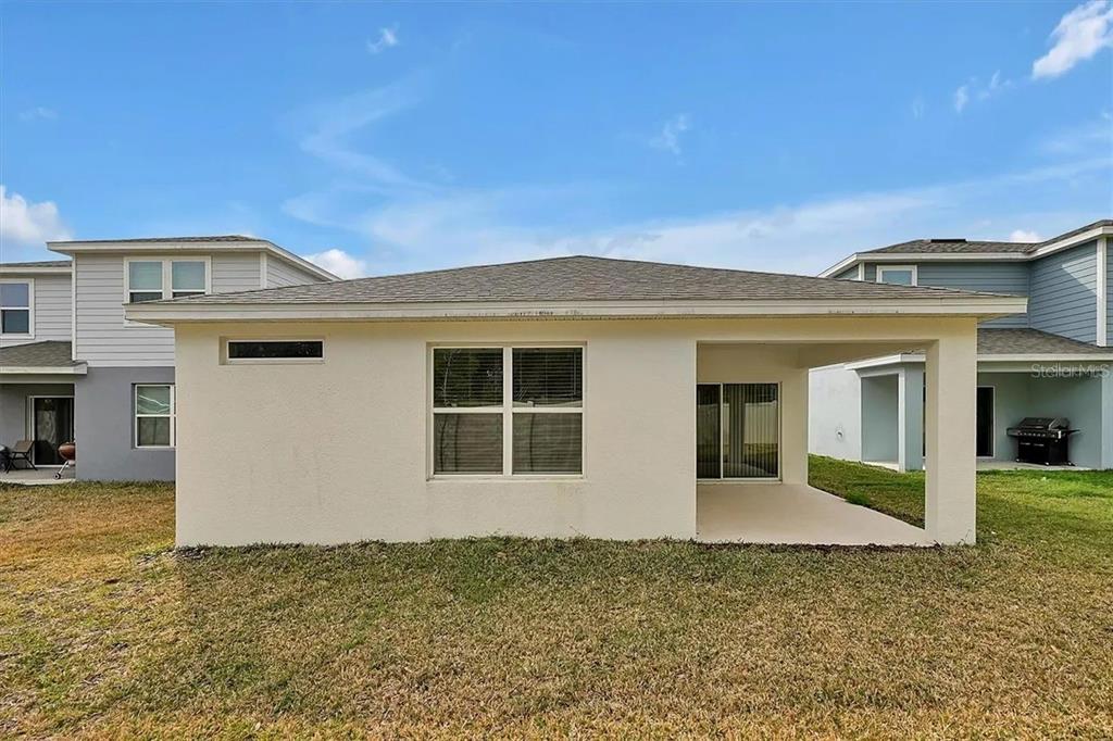 929 Rivers Crossing Street Clermont, FL 34714 - Photo 22 of 31 a view of a house with a backyard
