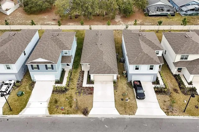 an aerial view of residential houses with outdoor space
