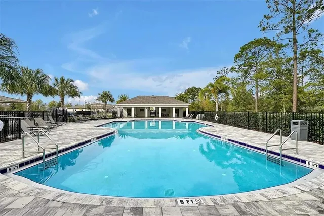 a view of a swimming pool with lounge chair