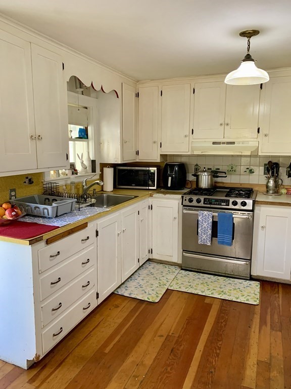 17 Everett Street Sherborn, MA 01770 - Photo 3 of 20 a kitchen with stainless steel appliances granite countertop a stove a sink and a refrigerator