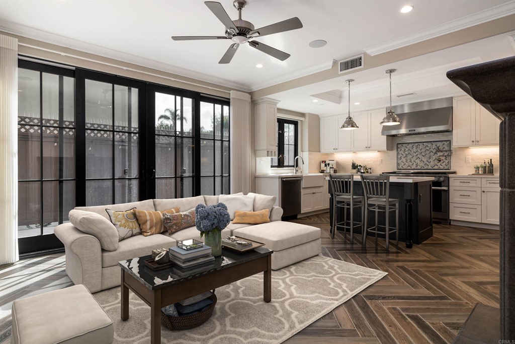 a living room with furniture and wooden floor