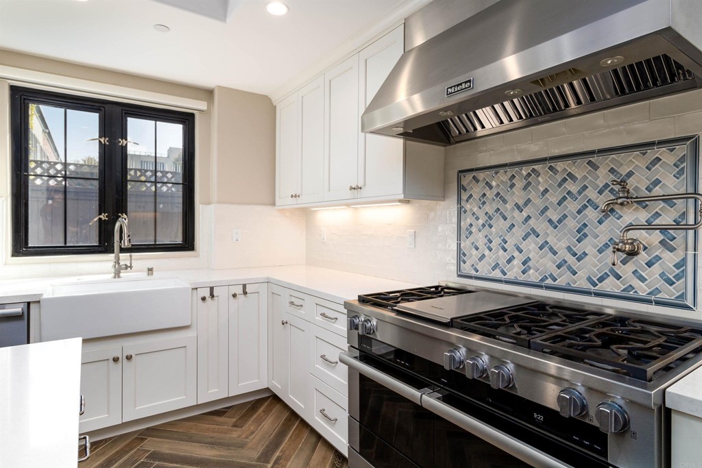728 Silver Street La Jolla, CA 92037 - Photo 14 of 44 a kitchen with a stove and a sink