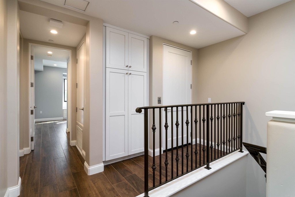 728 Silver Street La Jolla, CA 92037 - Photo 15 of 44 a view of a hallway with wooden floor and a bathroom