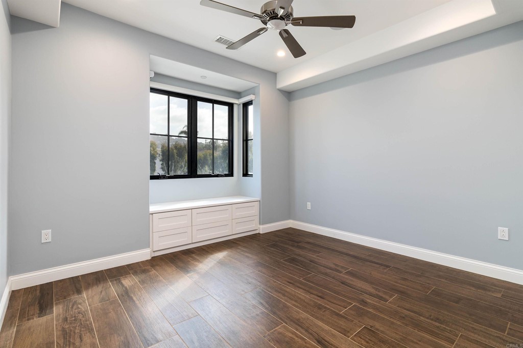 728 Silver Street La Jolla, CA 92037 - Photo 24 of 44 a view of an empty room with wooden floor and a window